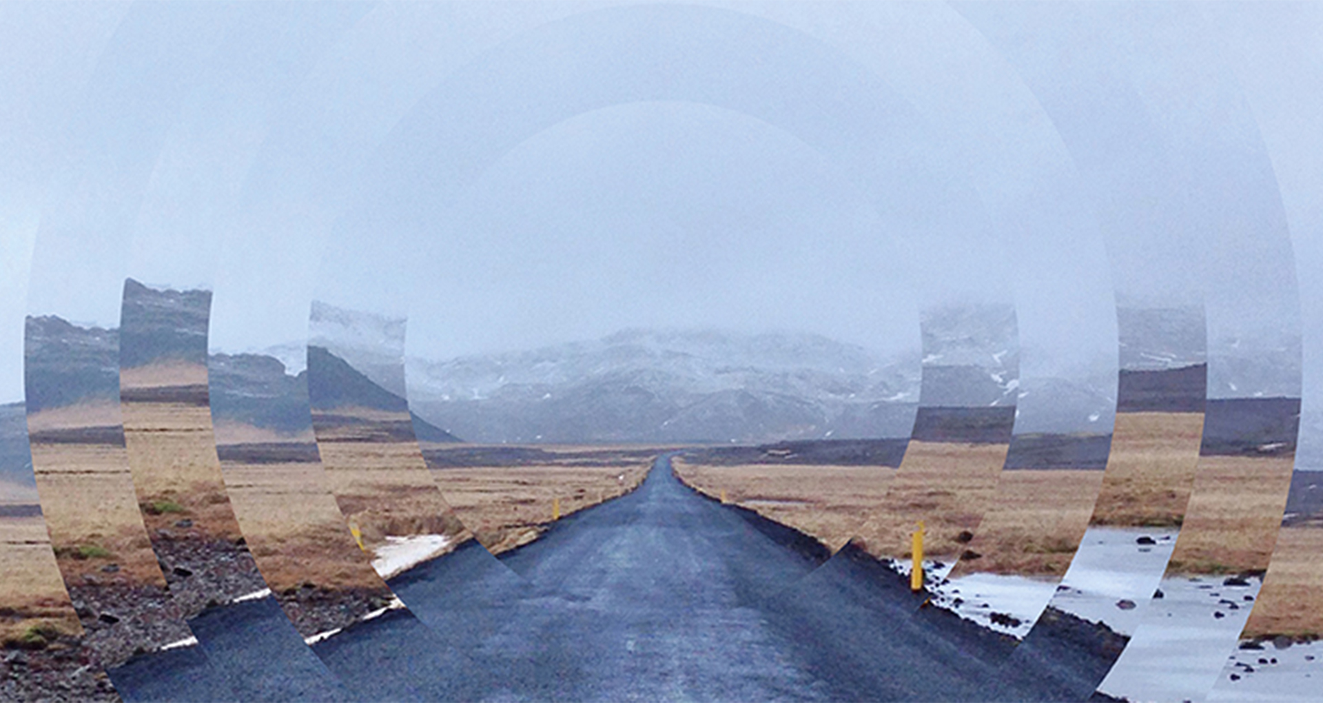 A road in a desert landscape. The image is cut on the sides